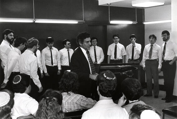 Black and white image of a group of men singing together